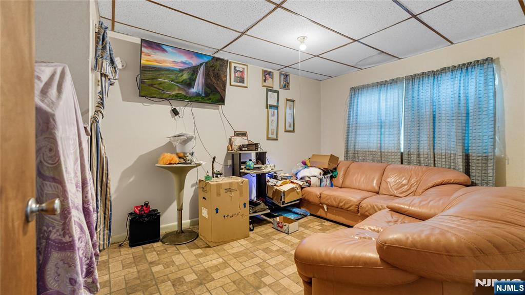 414 Market Street Paterson, NJ 07501 - Photo 2 of 9 a living room with furniture and a flat screen tv