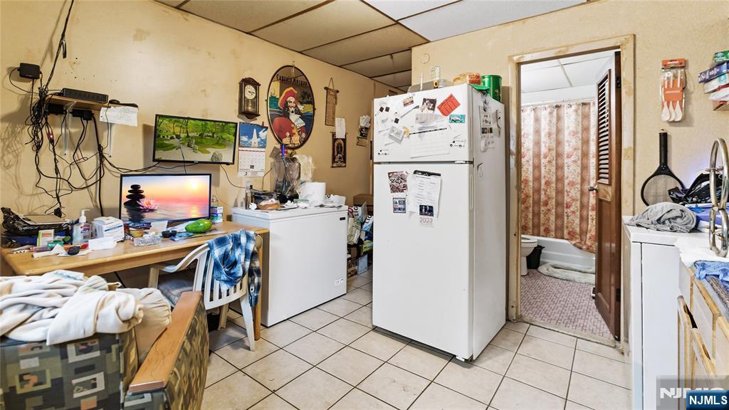 414 Market Street Paterson, NJ 07501 - Photo 4 of 9 a view of a kitchen with fridge and workspace
