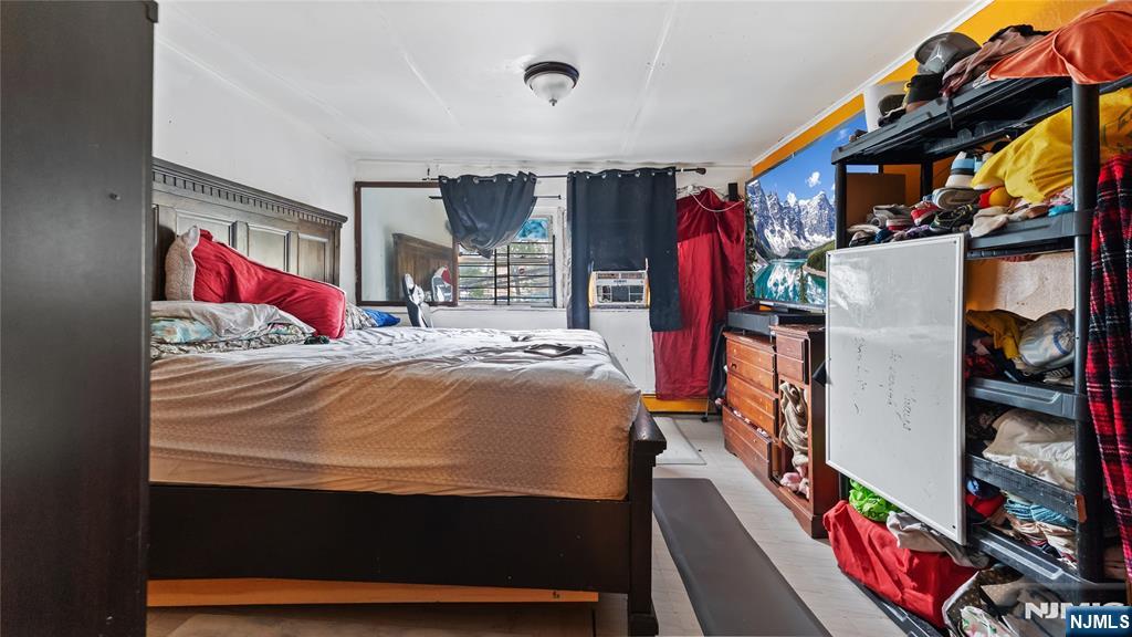 414 Market Street Paterson, NJ 07501 - Photo 6 of 9 a bed sitting in a bedroom next to a book shelf