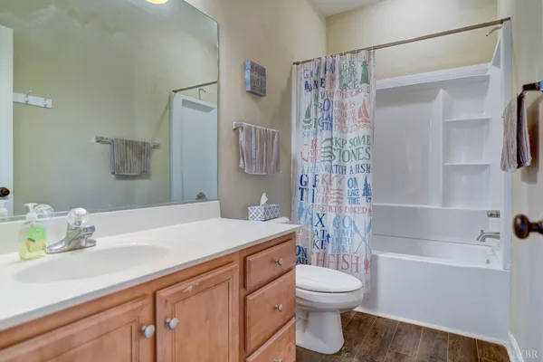 an aerial view of a house with a yard and a large tree
