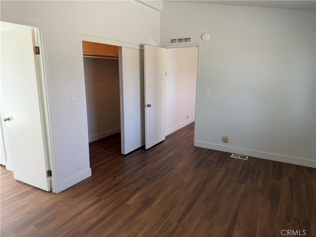 381 Amador Road Pinon Hills, CA 92372 - Photo 4 of 10 a view of an empty room with wooden floor and closet