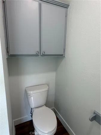 a white toilet sitting next to a sink