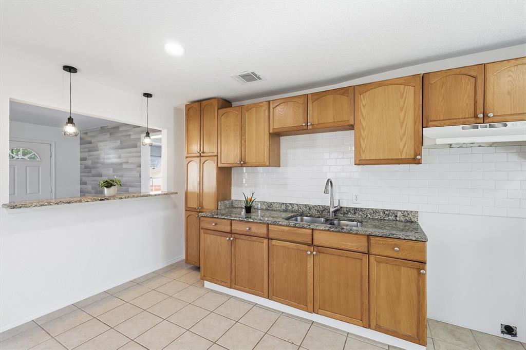 4024 Moler Street Dallas, TX 75211 - Photo 13 of 27 a kitchen with a sink window and cabinets