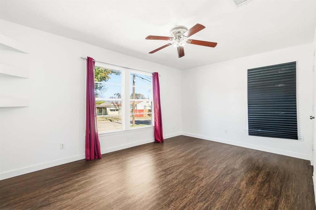 4024 Moler Street Dallas, TX 75211 - Photo 16 of 27 an empty room with wooden floor fan and windows