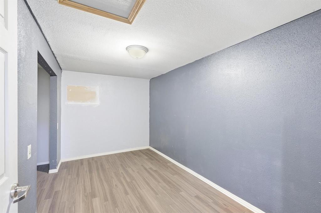 4024 Moler Street Dallas, TX 75211 - Photo 22 of 27 an empty room with wooden floor and windows