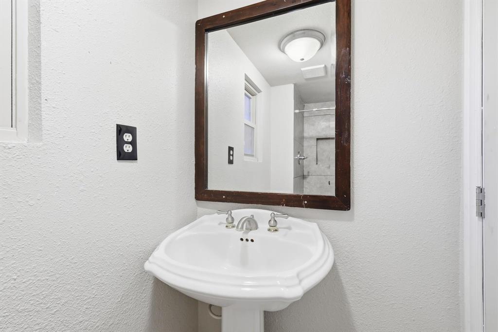4024 Moler Street Dallas, TX 75211 - Photo 24 of 27 a bathroom with a sink and a mirror