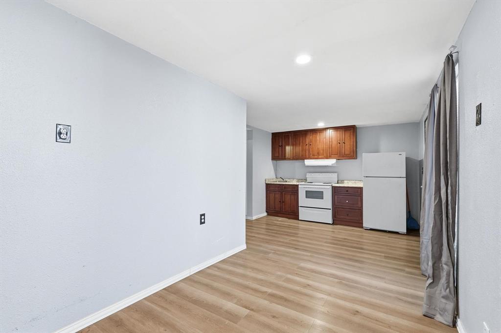 4024 Moler Street Dallas, TX 75211 - Photo 25 of 27 a kitchen with stainless steel appliances a refrigerator and a stove top oven