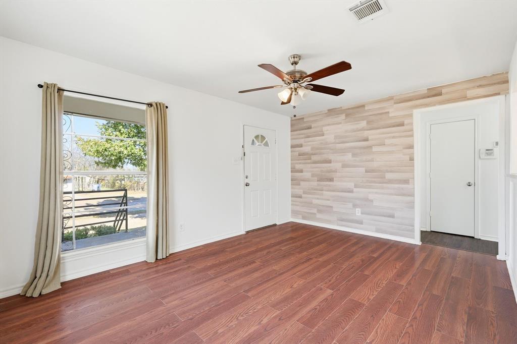4024 Moler Street Dallas, TX 75211 - Photo 7 of 27 a view of empty room with wooden floor and fan