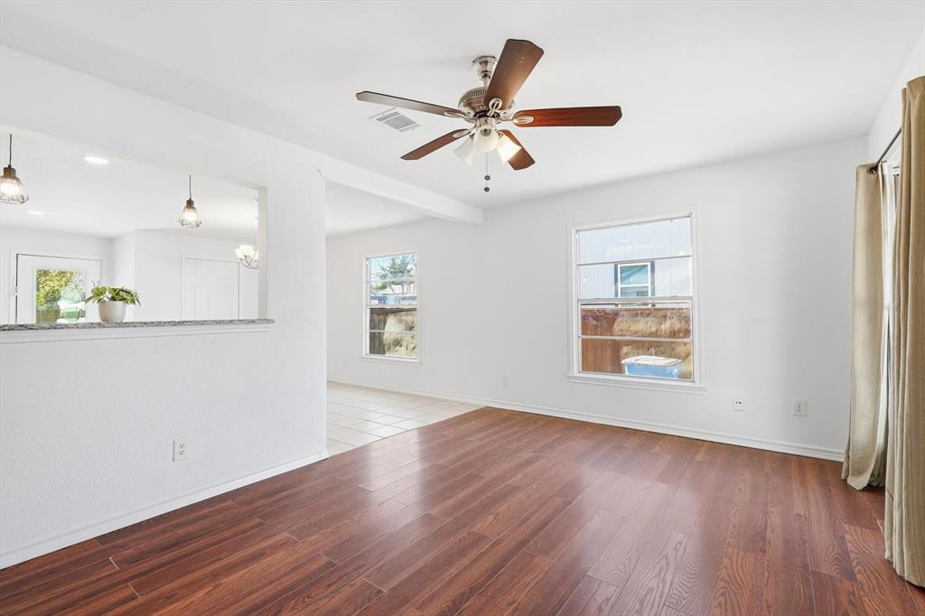 4024 Moler Street Dallas, TX 75211 - Photo 8 of 27 a view of an empty room with window and wooden floor