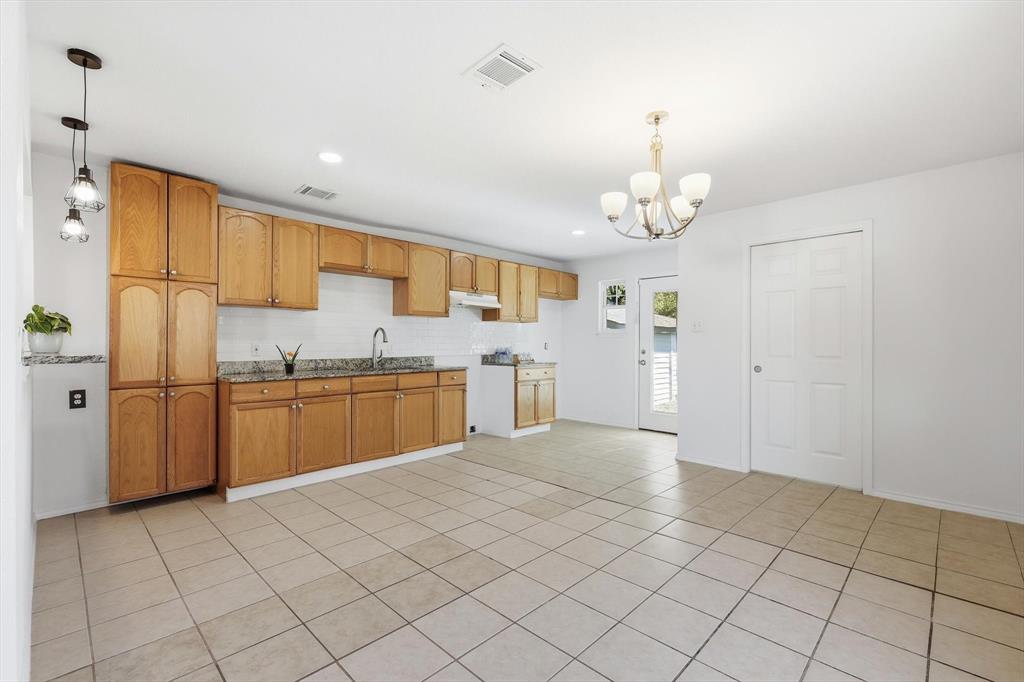 4024 Moler Street Dallas, TX 75211 - Photo 9 of 27 a kitchen with a sink a counter top space cabinets and stainless steel appliances