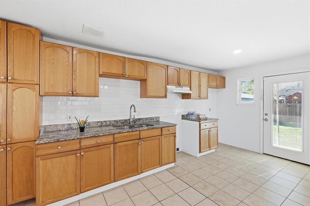 4024 Moler Street Dallas, TX 75211 - Photo 10 of 27 a kitchen with stainless steel appliances granite countertop a sink and cabinets