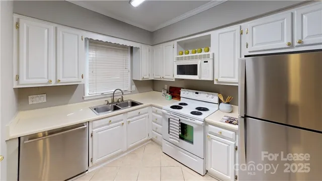 a kitchen with a white cabinets sink and white appliances