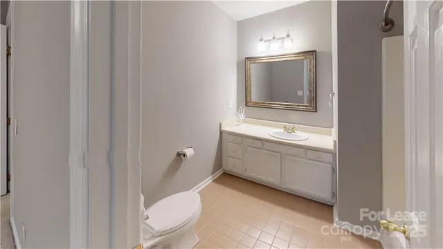 a bathroom with a sink a toilet and mirror