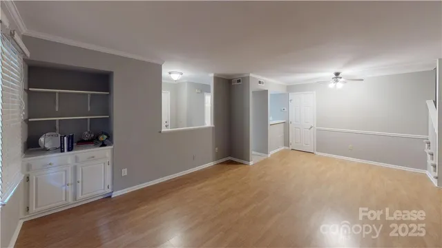 a view of an empty room with a kitchen