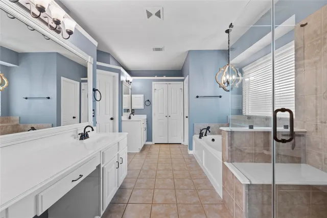 a bathroom with a tub a sink and a shower