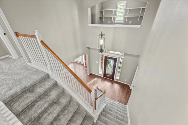 a view of a livingroom with a chandelier fan and a large window