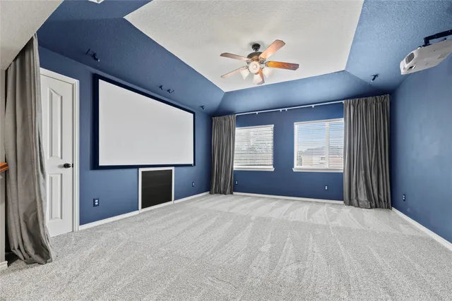 a view of room with window and ceiling fan