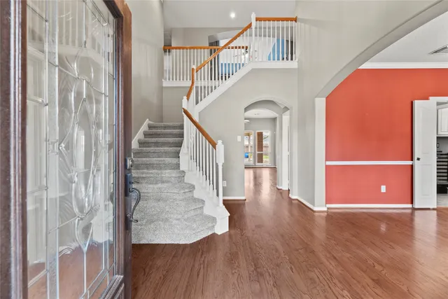 a view of entryway and hall with wooden floor