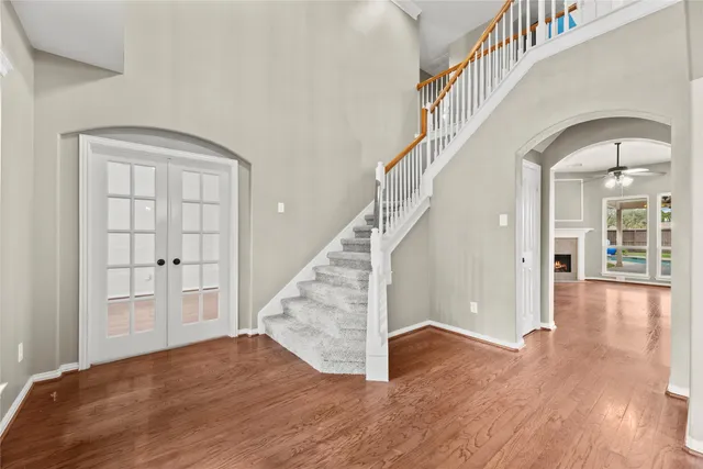 a view of entryway and hall with wooden floor