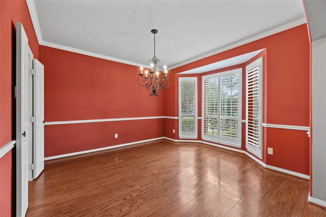 a view of a livingroom with wooden floor and a window