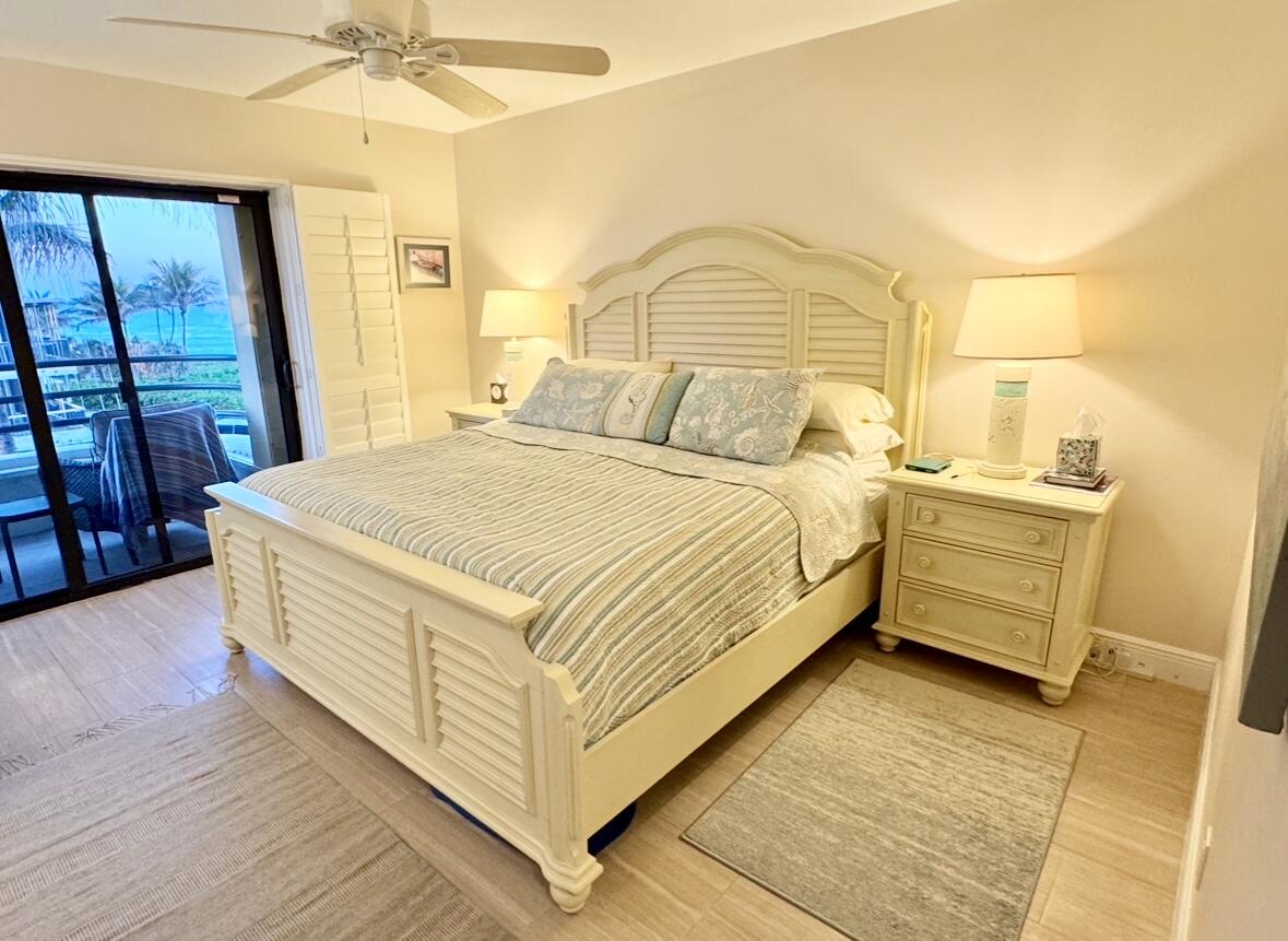 420 Celestial Way, Unit 403 Juno Beach, FL 33408 - Photo 14 of 25 a bedroom with a bed and a dresser