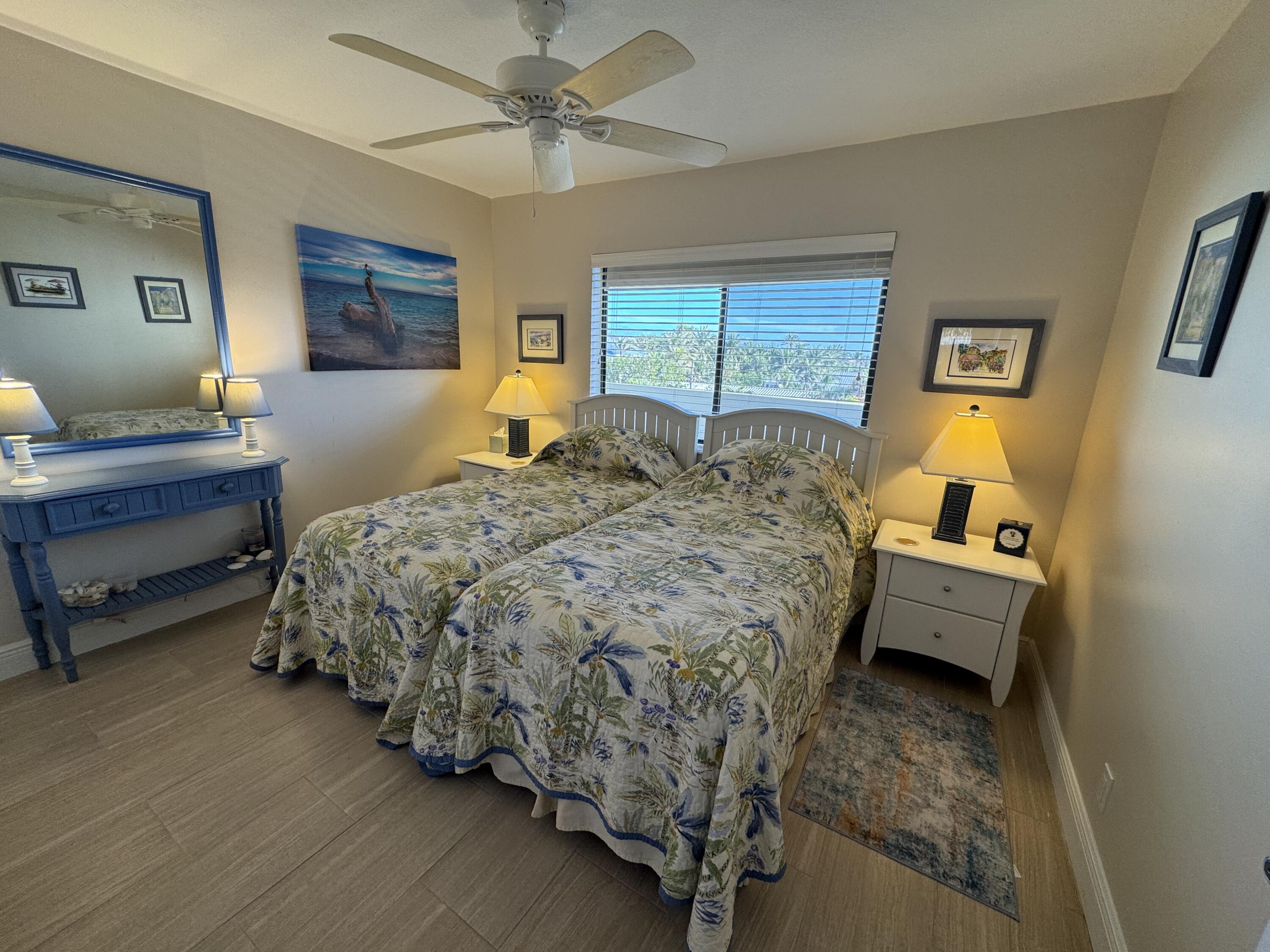 420 Celestial Way, Unit 403 Juno Beach, FL 33408 - Photo 16 of 25 a bedroom with a bed and wooden floor