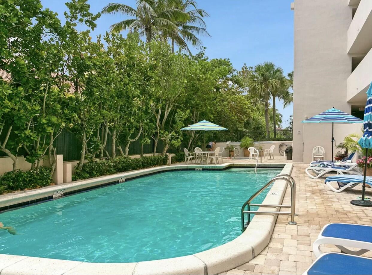 420 Celestial Way, Unit 403 Juno Beach, FL 33408 - Photo 8 of 25 a view of a swimming pool and lounge chair