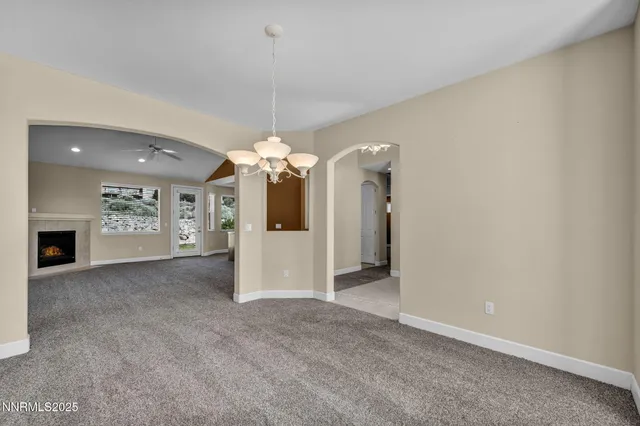 a view of a room with window wooden floor and front door