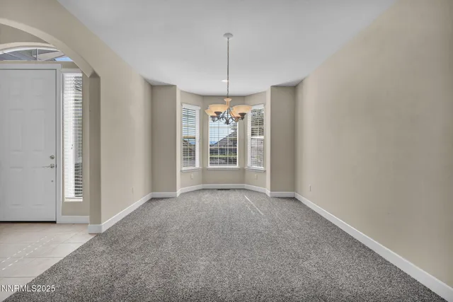 a view of an empty room with a fireplace