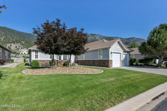 a front view of a house with a yard porch and outdoor seating