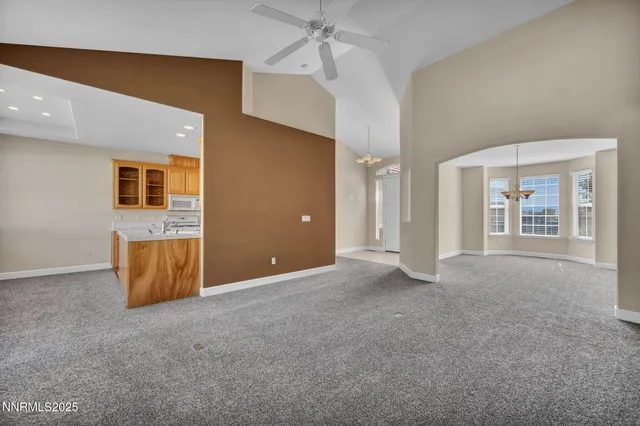 a kitchen with granite countertop a stove sink and cabinets