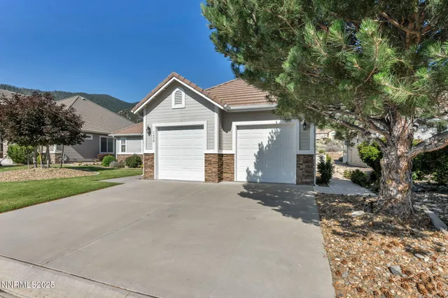 a front view of a house with a yard and garage
