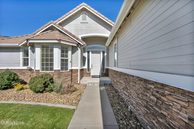 a front view of a house with a garden
