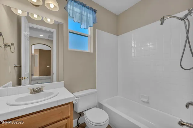 a aerial view of a house with a big yard and large tree