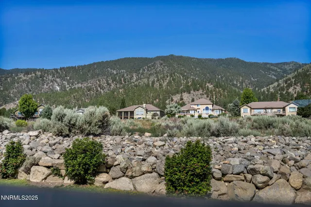 a view of a mountain with a yard