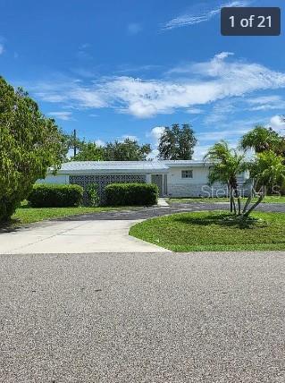 158 Concord Drive Northeast Port Charlotte, FL 33952 - Photo 1 of 21 a view of a garden and basketball court