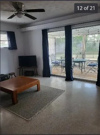 a bedroom with furniture and large windows