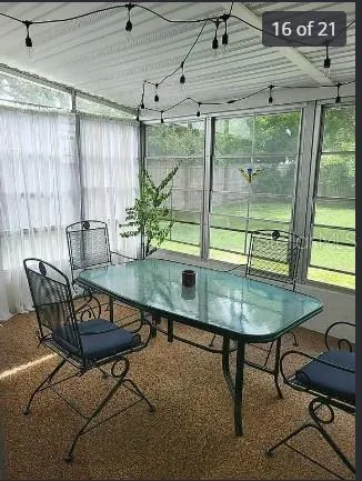 a dining room with furniture and window
