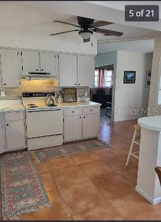 158 Concord Drive Northeast Port Charlotte, FL 33952 - Photo 5 of 21 a kitchen with a stove a sink and a refrigerator