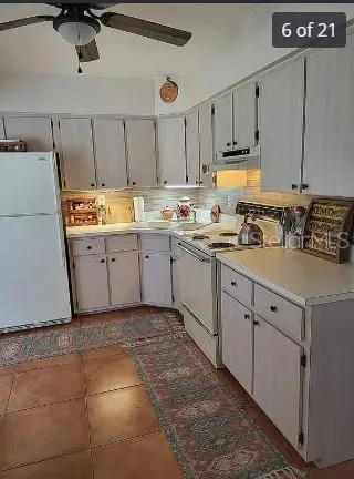 a kitchen with a sink cabinets and window