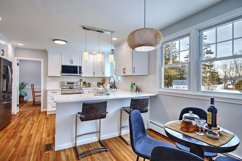 3 Pinetop Road Barrington, RI 02806 - Photo 15 of 38 a kitchen with a dining table chairs and white appliances