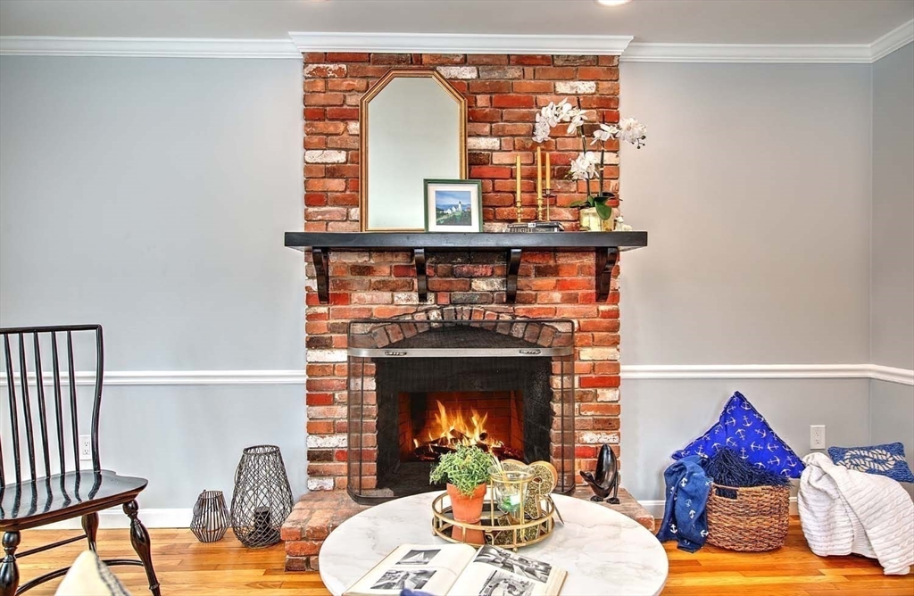 3 Pinetop Road Barrington, RI 02806 - Photo 18 of 38 a living room with furniture a table and a fireplace