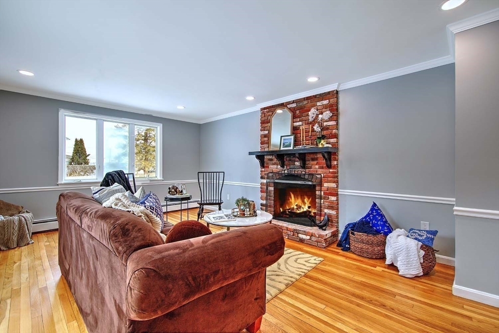 3 Pinetop Road Barrington, RI 02806 - Photo 19 of 38 a living room with furniture a fireplace and a large window