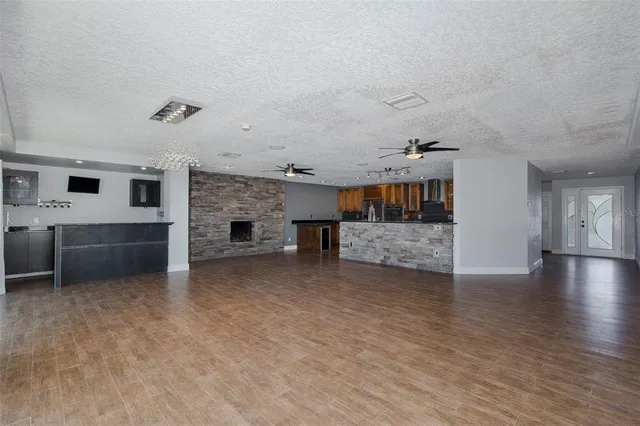 an empty room with fireplace and windows