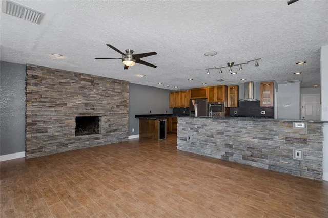 a kitchen with stainless steel appliances granite countertop a refrigerator and a stove