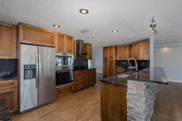 a kitchen with stainless steel appliances a stove sink microwave and cabinets