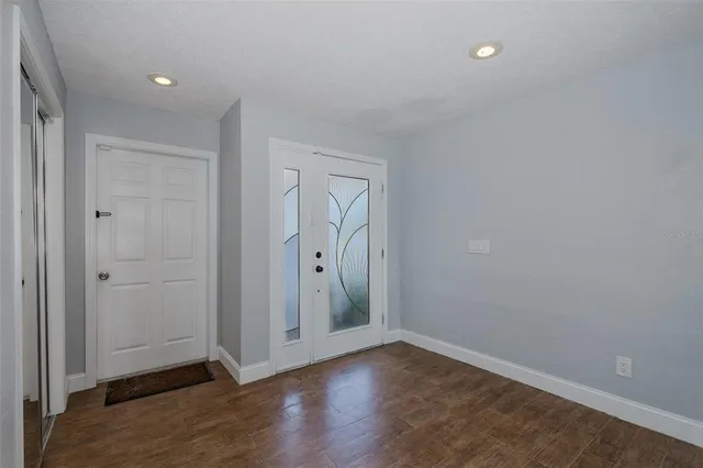 a view of an empty room and wooden floor