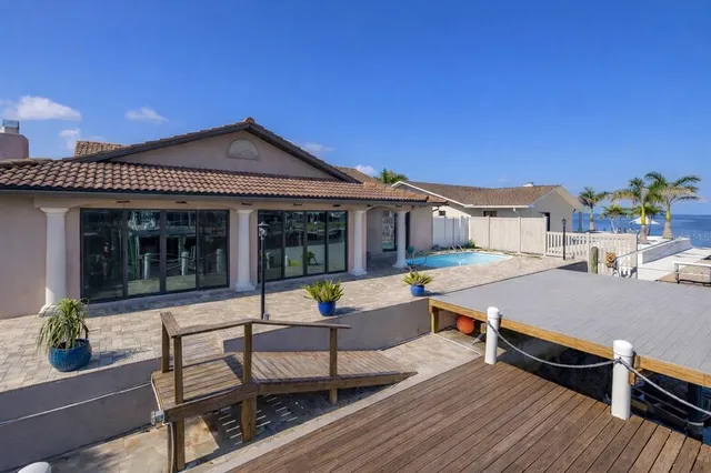 a view of a roof deck with furniture