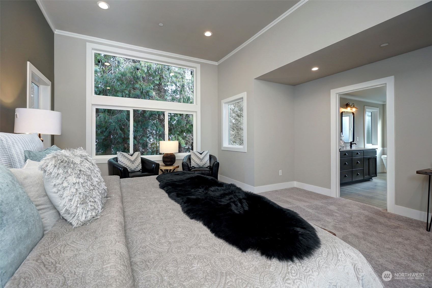 18146 94th Avenue Northeast Bothell, WA 98011 - Photo 27 of 37 a bedroom with a large bed and large windows