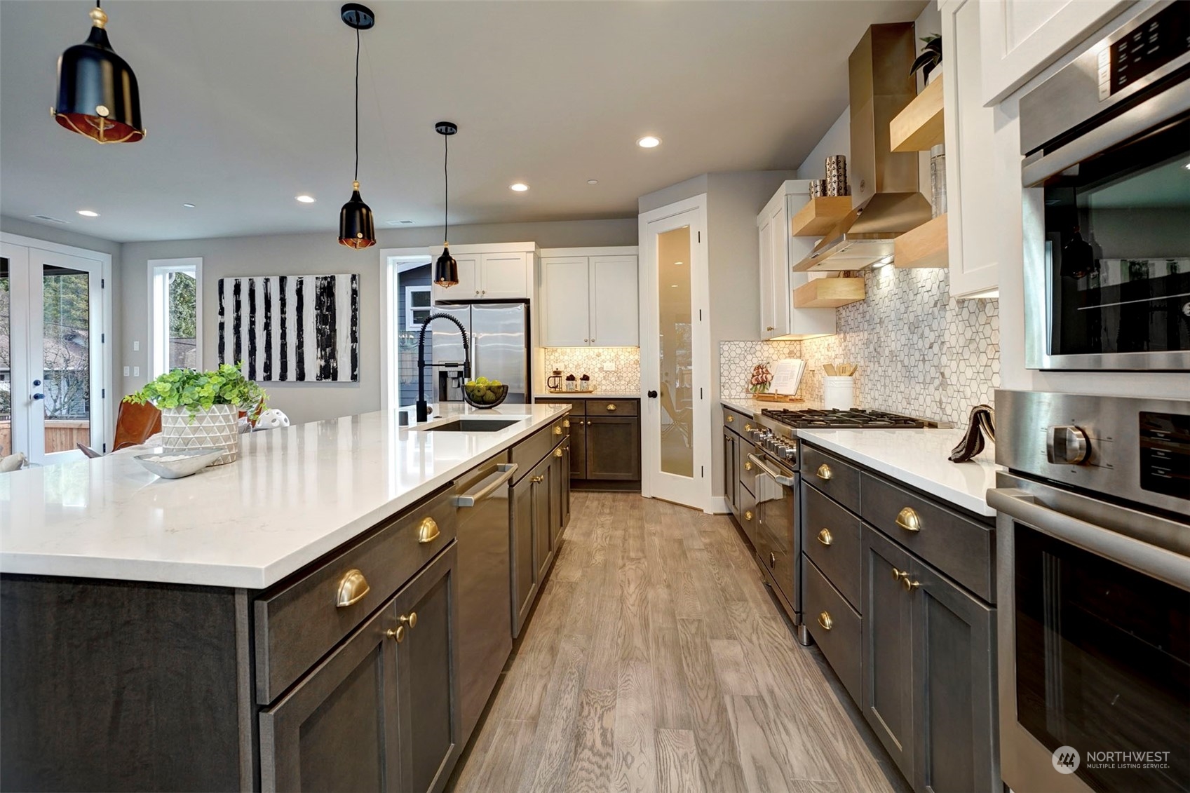 18146 94th Avenue Northeast Bothell, WA 98011 - Photo 6 of 37 a kitchen with stainless steel appliances kitchen island granite countertop a sink a stove top oven a counter space and cabinets